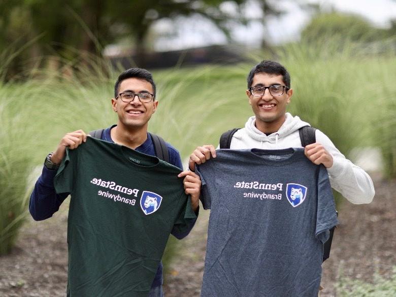 Male students posing with new Brandywine t-shirts